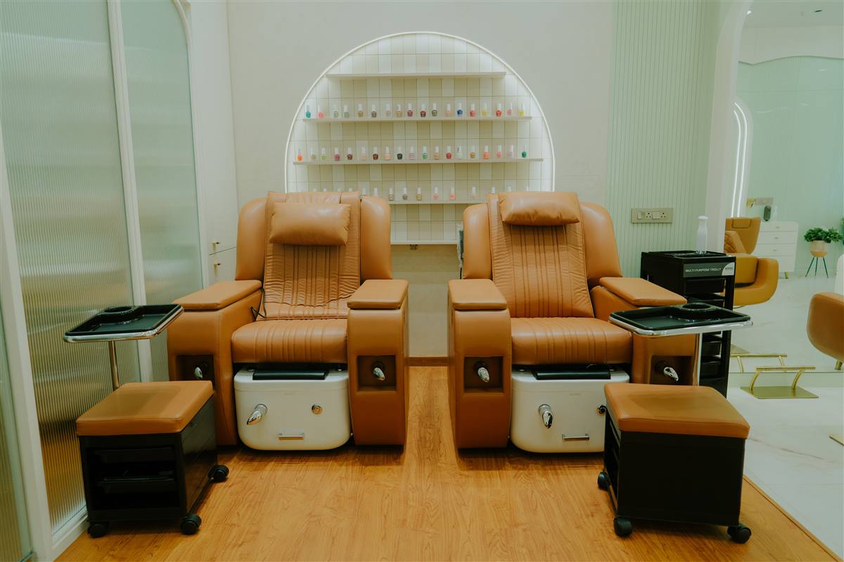 OMORFIA The Salon interior — white arched salon with golden styling chairs, Bodakdev Ahmedabad