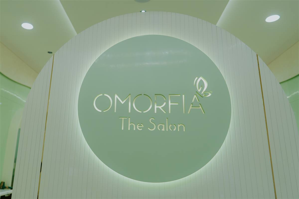OMORFIA The Salon — illuminated sign with butterfly logo in the studio, Bodakdev Ahmedabad